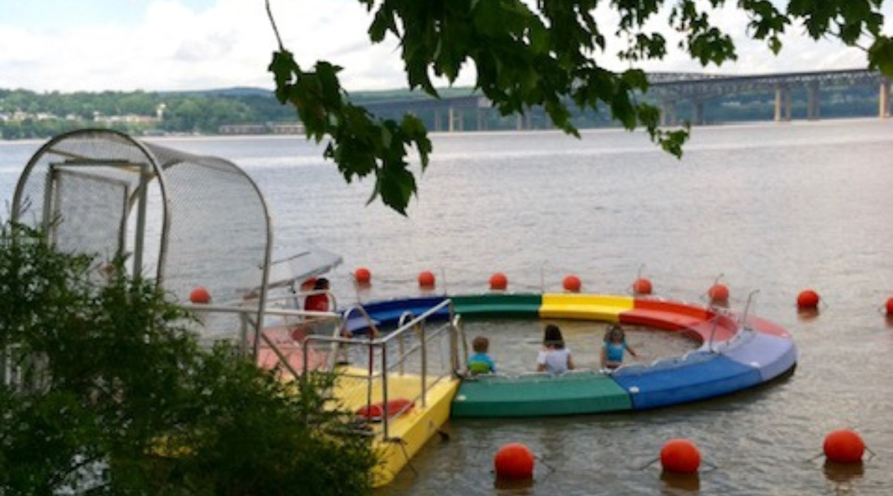 Riverpool at Beacon in the Hudson River with kids swimming in front of MidHudson Bridge
